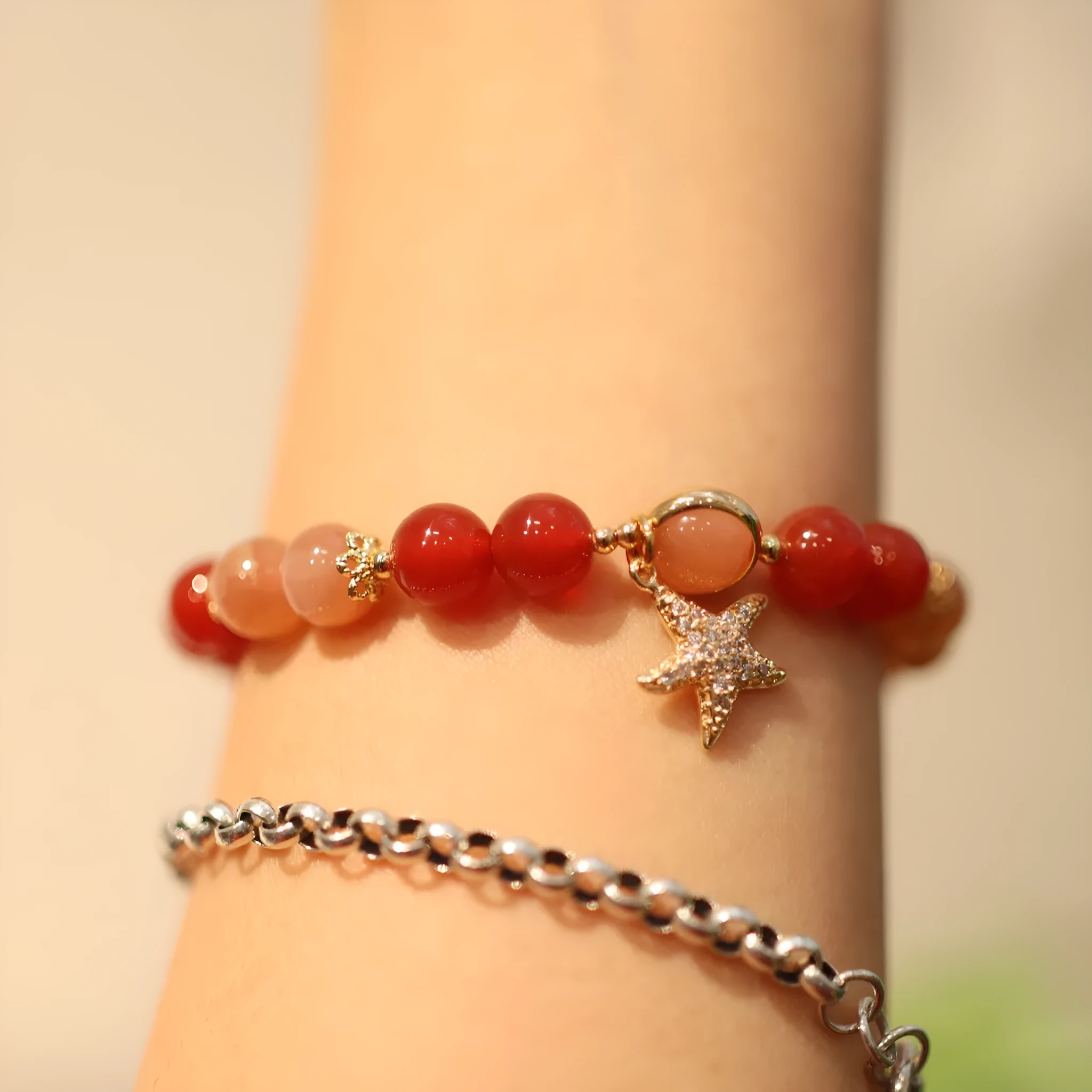 Handmade red agate and sunstone bracelet with carved xiangyun ethnic motifs, 8mm bead diameter