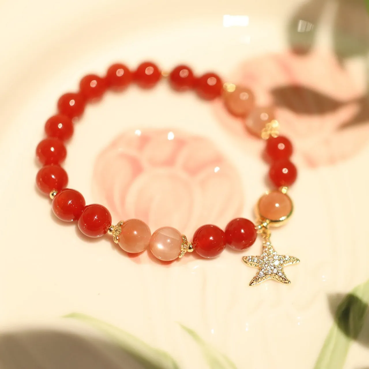 Handmade red agate and sunstone bracelet with carved xiangyun ethnic motifs, 8mm bead diameter