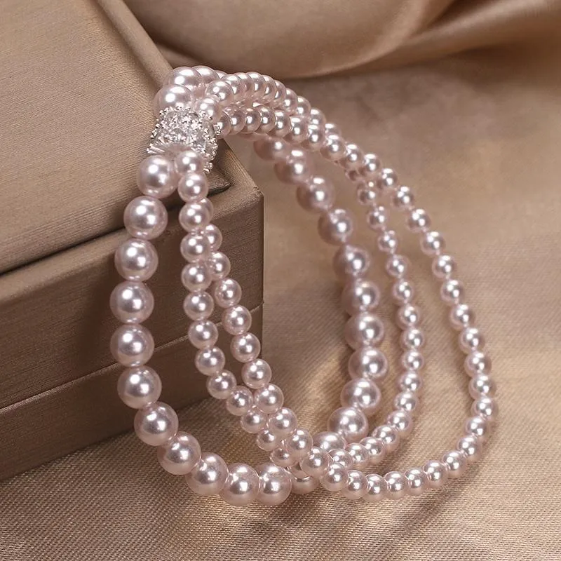 Baroque pearl multi-layer twin bracelet in white with electroplated finish on neutral background