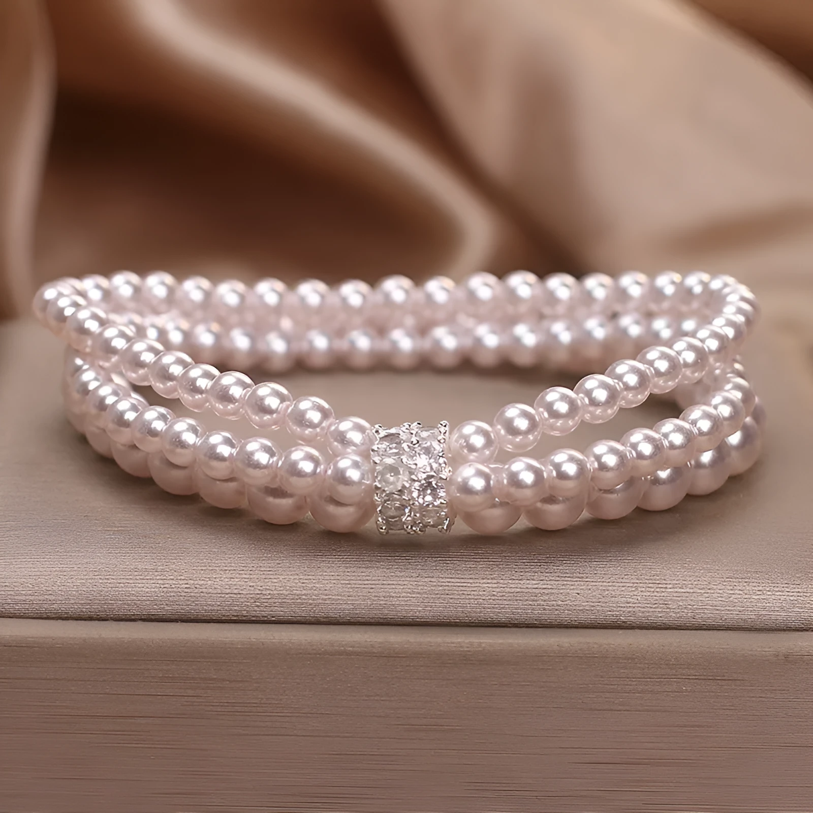 Baroque pearl multi-layer twin bracelet in white with electroplated finish on neutral background