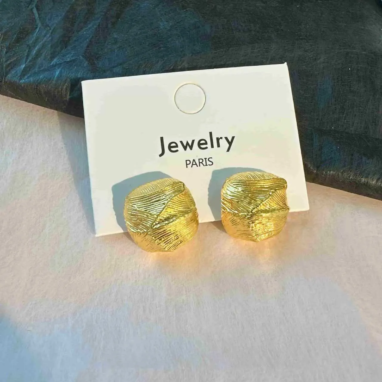 Minimalist metal alloy stud earrings with a simple circle design on a white background.