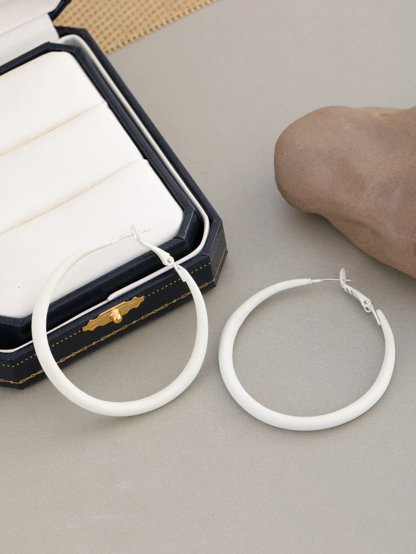 Two tone gradient exaggerated circle earrings on display showing colour transition and hoop shape