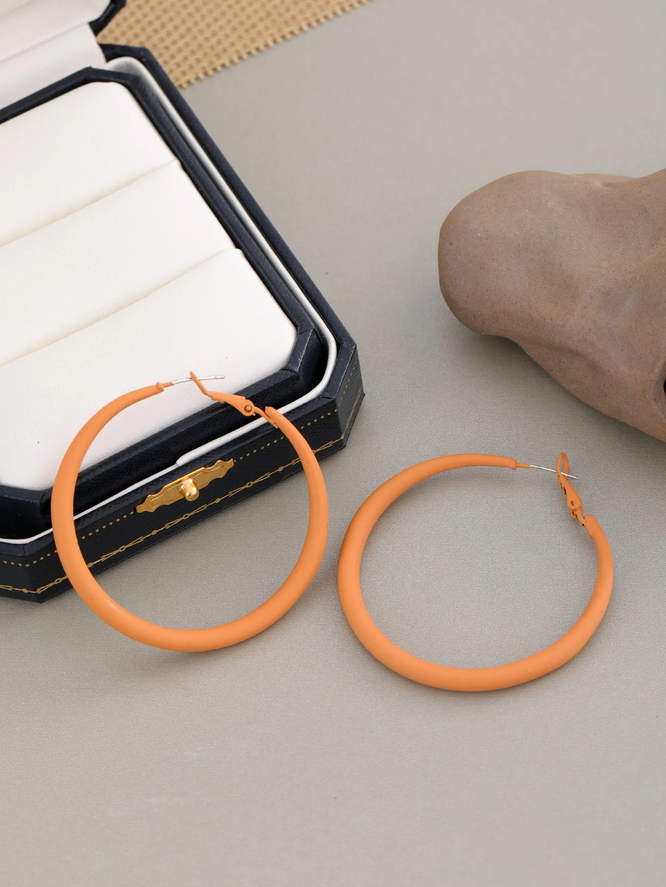 Two tone gradient exaggerated circle earrings on display showing colour transition and hoop shape
