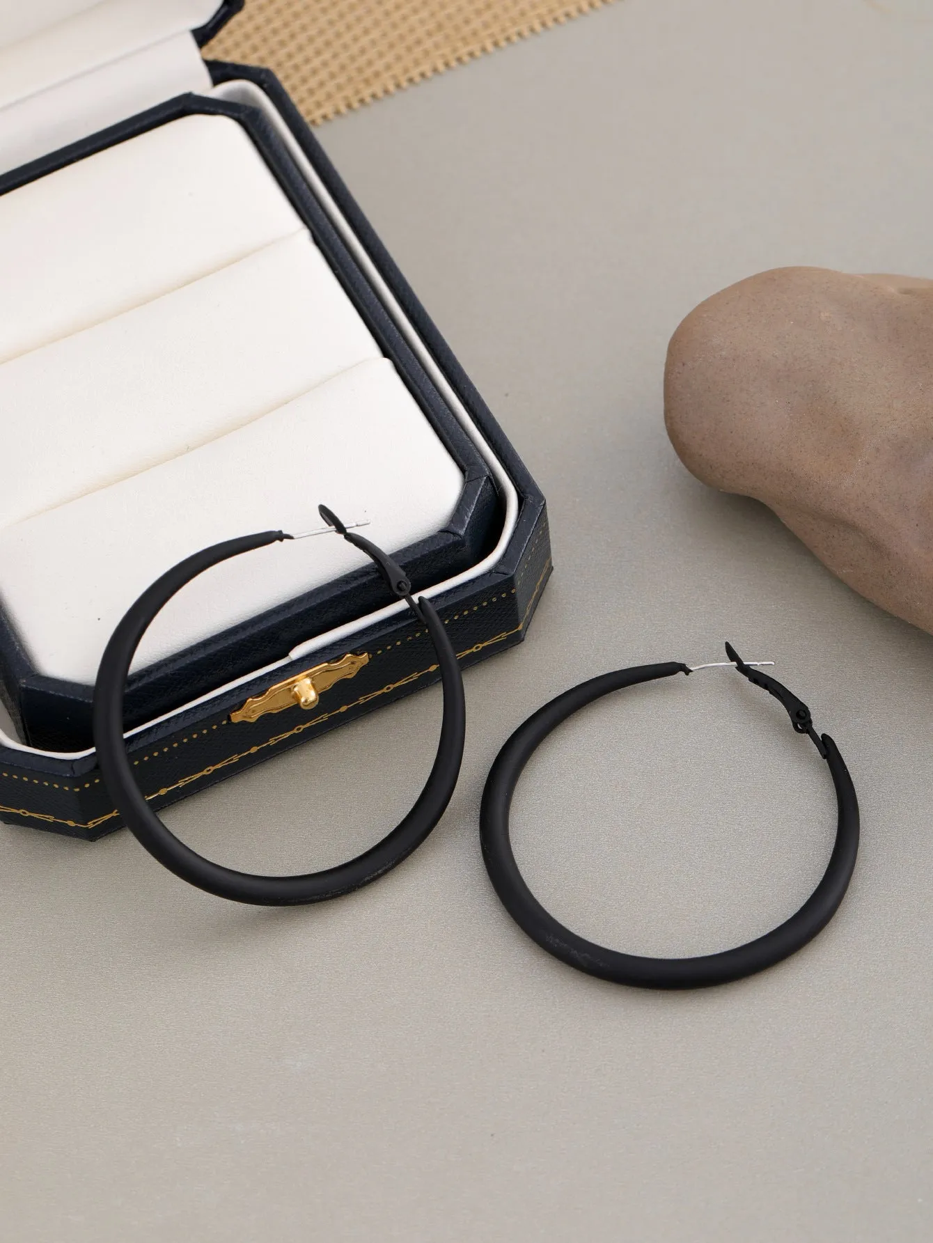Two tone gradient exaggerated circle earrings on display showing colour transition and hoop shape
