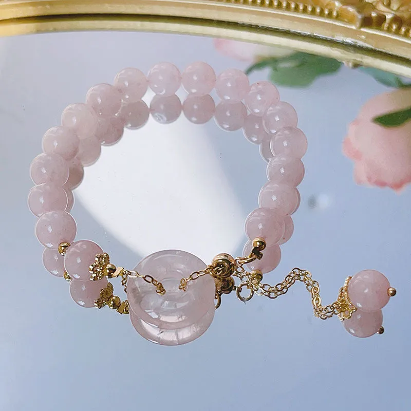 Pink crystal peace buckle bracelet with safety clasp on silver-coloured chain