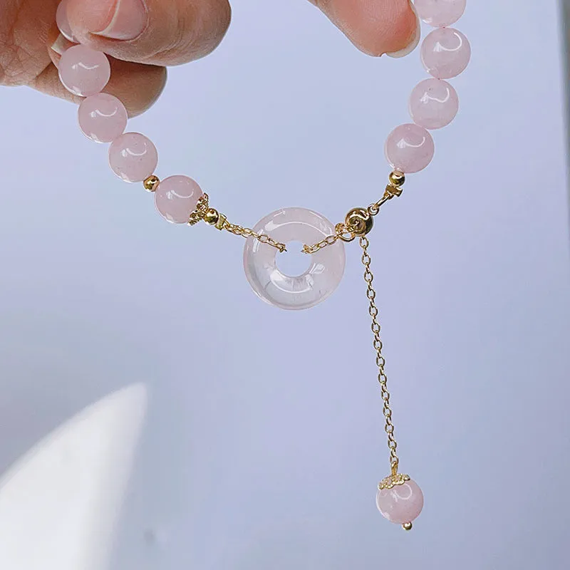 Pink crystal peace buckle bracelet with safety clasp on silver-coloured chain