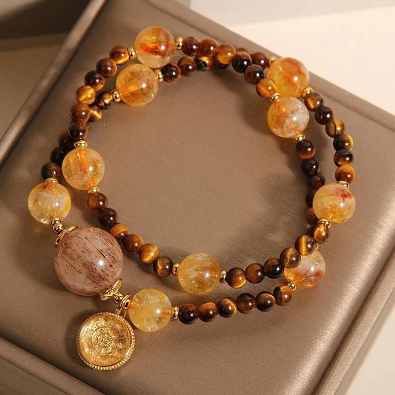 Double circle natural citrine tiger-eye bracelet with yellow tower crystal on white background