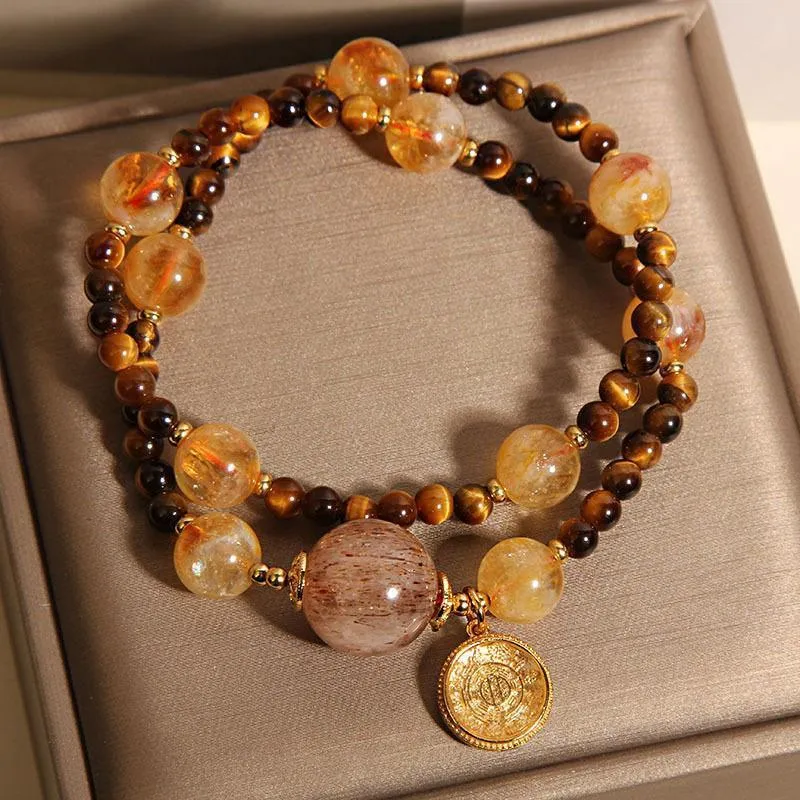 Double circle natural citrine tiger-eye bracelet with yellow tower crystal on white background