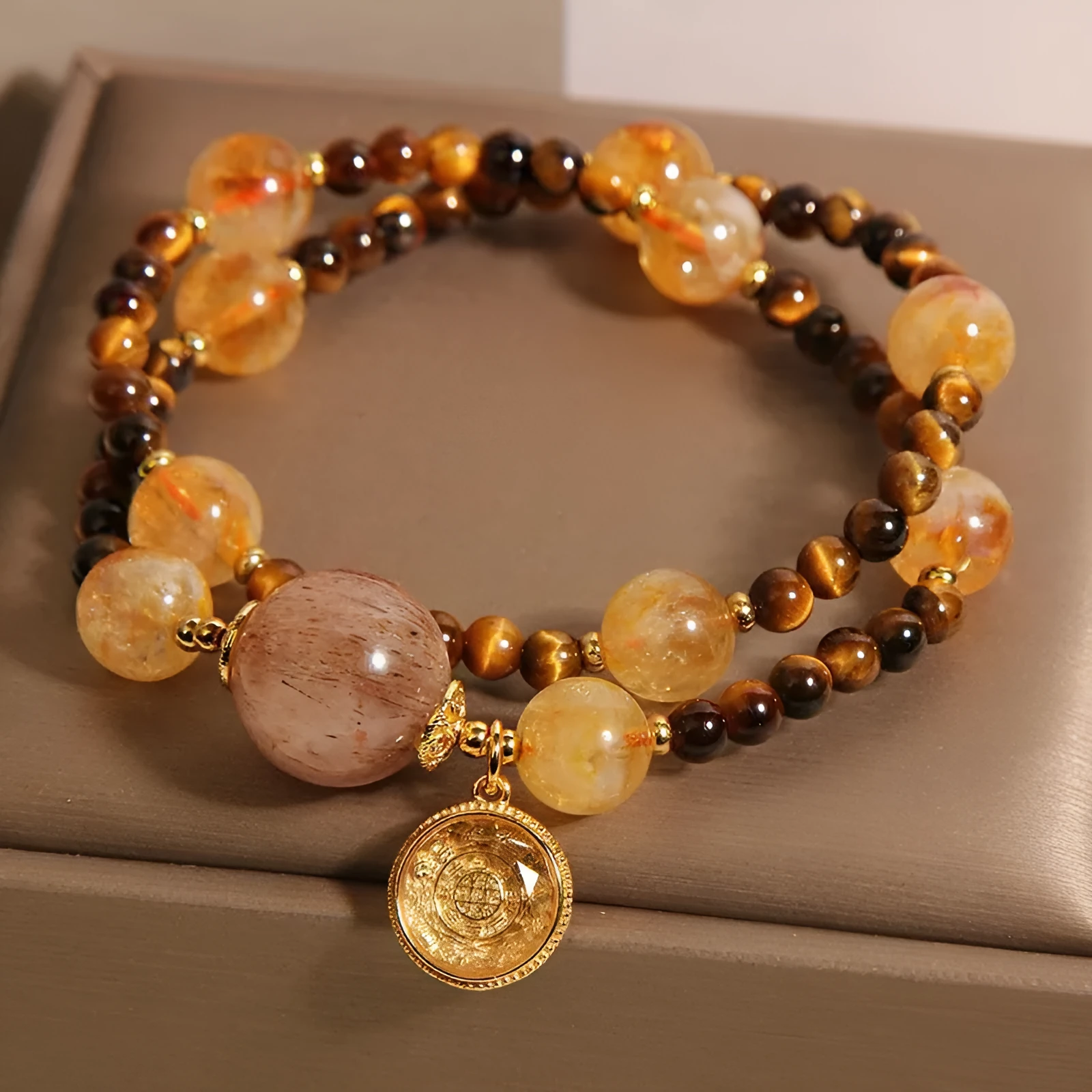 Double circle natural citrine tiger-eye bracelet with yellow tower crystal on white background