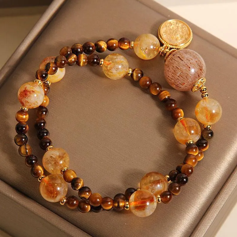 Double circle natural citrine tiger-eye bracelet with yellow tower crystal on white background
