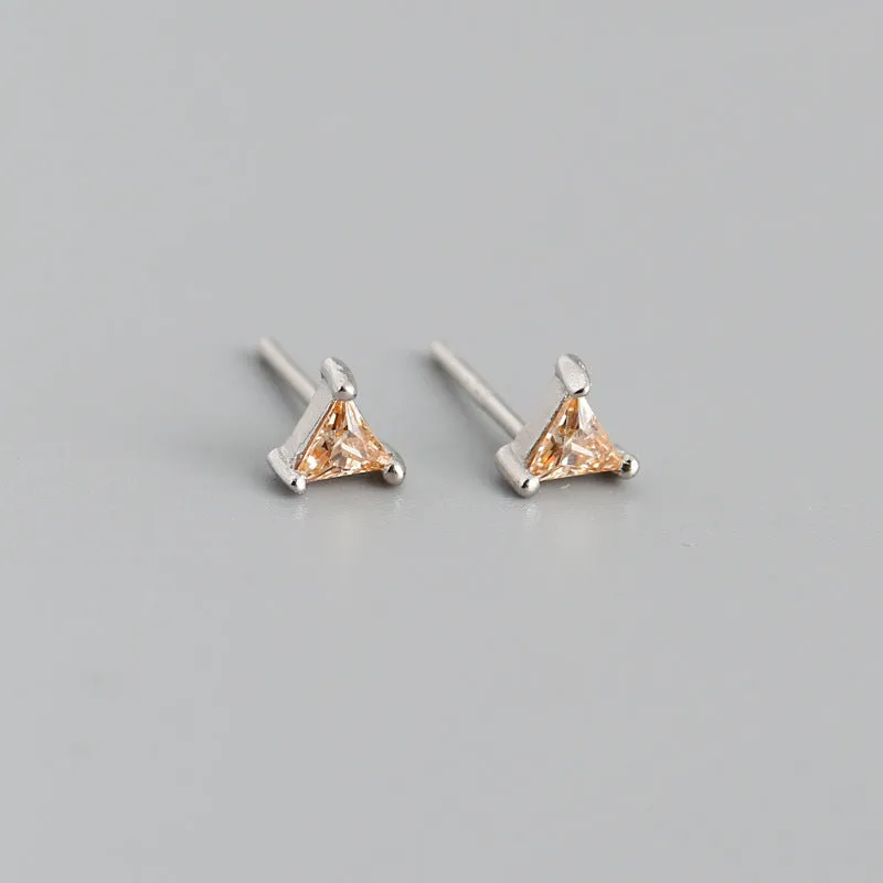 Simple triangle colour zircon stud earrings in 925 sterling silver with blue stone and gold needle on white background