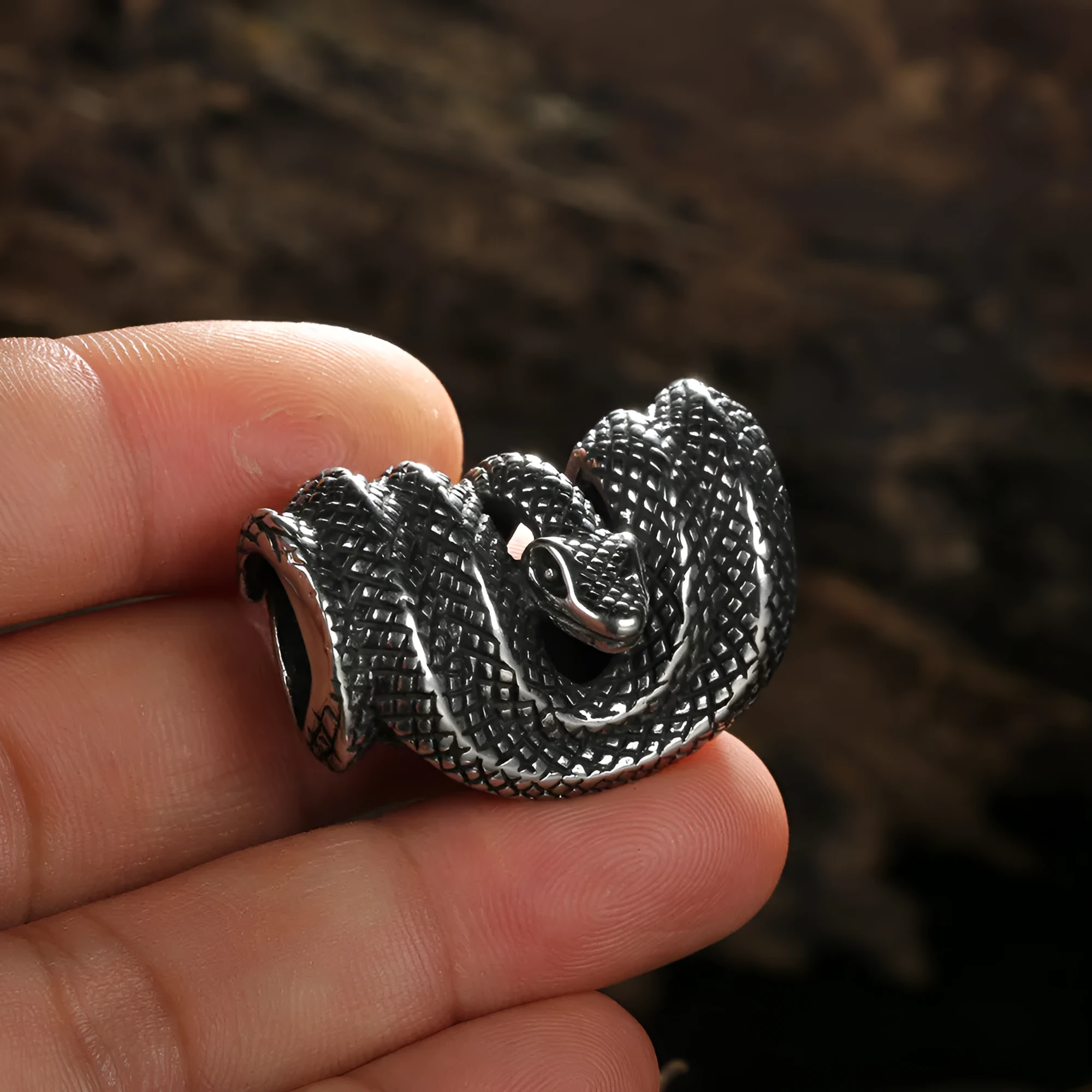 Geometric stainless steel Python pendant necklace in single pendant steel colour on a plain background