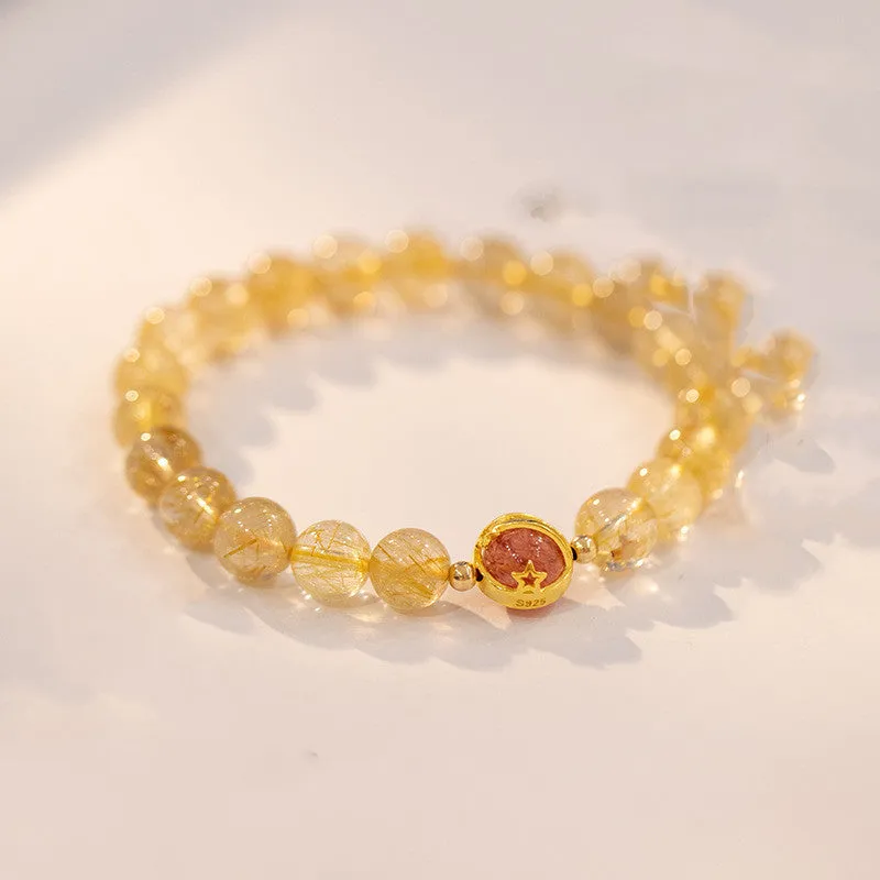 Citrine and gold rutilated quartz bracelet with diamond-cut beads in 6mm or 8mm size on a wrist.