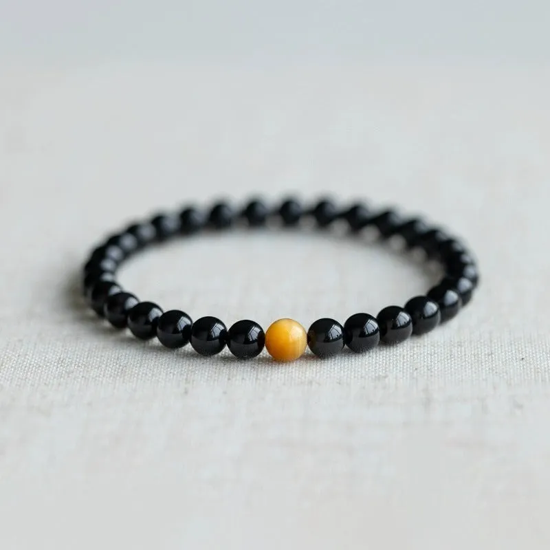 Black geometric obsidian bead bracelet shown in three size options: 6mm, 8mm, and 10mm beads.