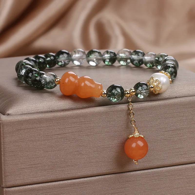 Green phantom quartz crystal bracelet with pearl and rhinestone accents on a white background, 17cm women's size