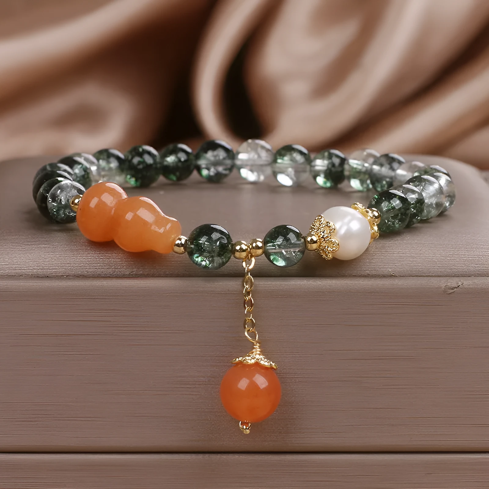 Green phantom quartz crystal bracelet with pearl and rhinestone accents on a white background, 17cm women's size