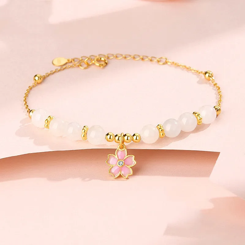 Pink women's bracelet with 925 silver cherry blossom pendant, Hetian jade beads, and gradient epoxy details.