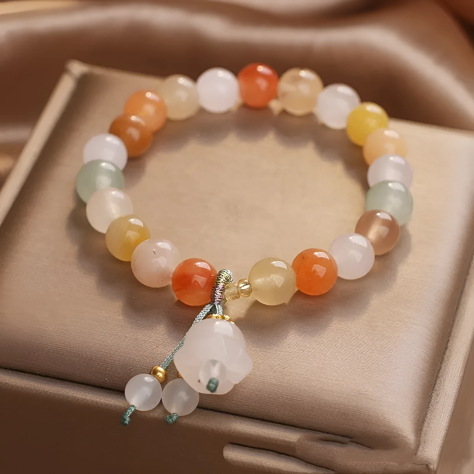Natural Jinsi Jade round bead beaded bracelet with lily pendant on neutral background