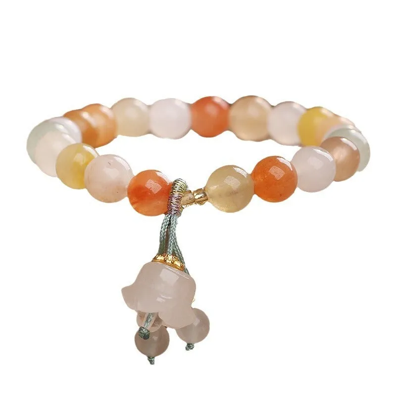 Natural Jinsi Jade round bead beaded bracelet with lily pendant on neutral background