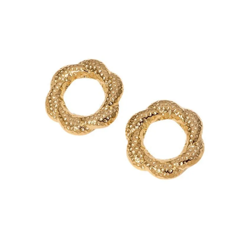 Stainless steel round stud earrings in gold and steel colours on a neutral background