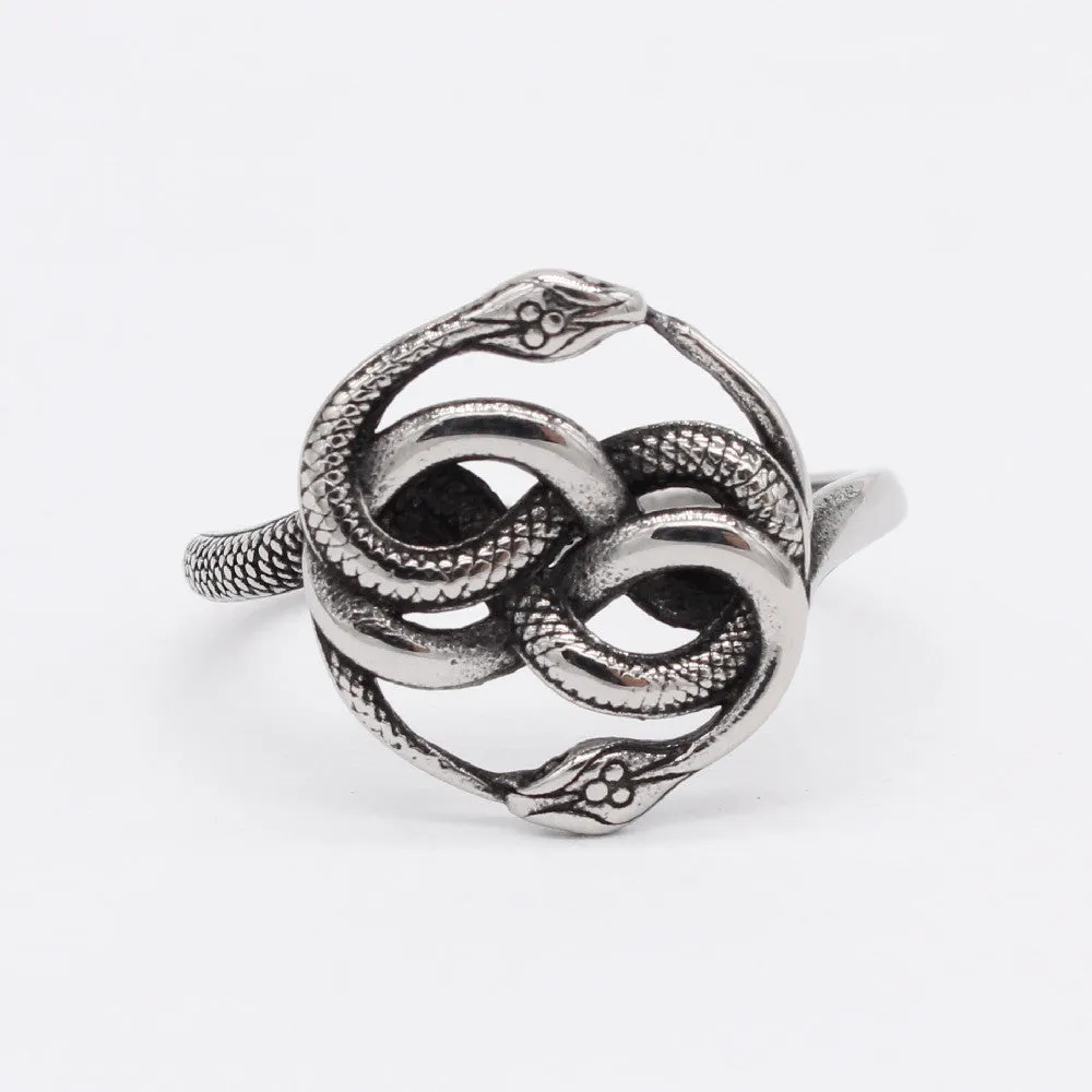 Close-up of a titanium steel double snake ring with a retro design on a hand, showing the intricate intertwined serpent detail.