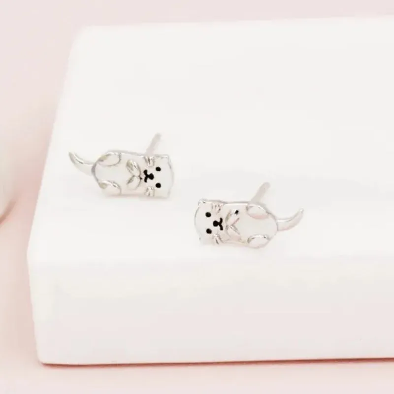 Simple compact three-dimensional animal-shaped copper earrings with electroplated finish in white gold colour