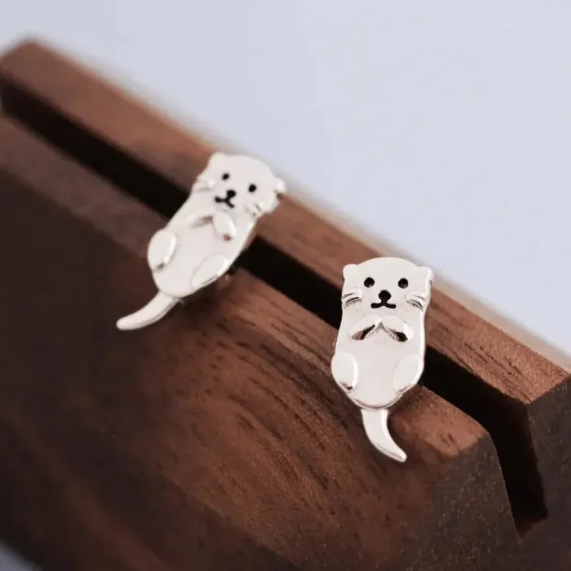 Simple compact three-dimensional animal-shaped copper earrings with electroplated finish in white gold colour