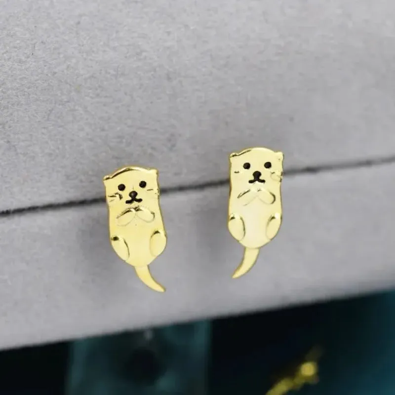 Simple compact three-dimensional animal-shaped copper earrings with electroplated finish in white gold colour