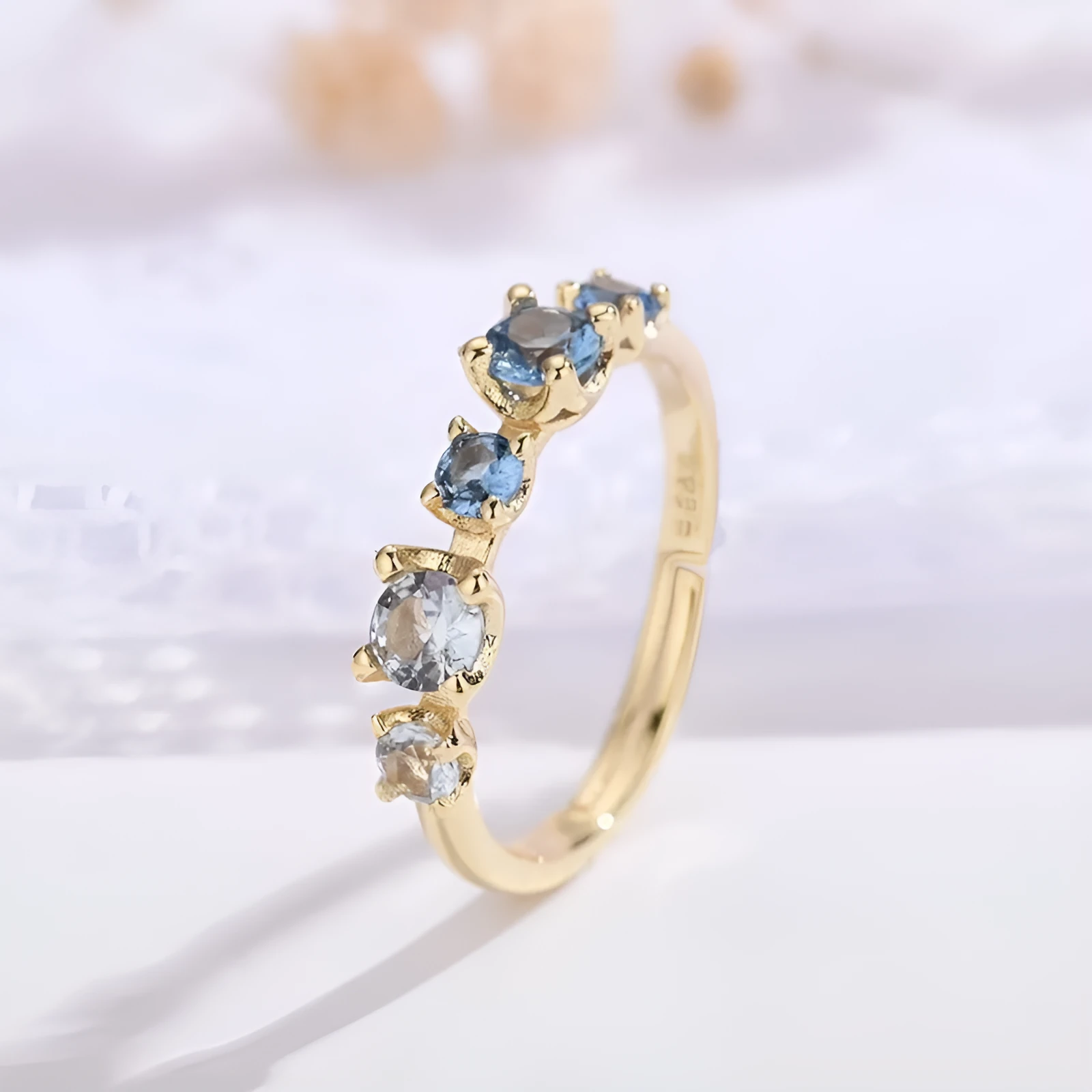 Gradient blue and white topaz multi-gemstone zircon ring with adjustable open mouth design