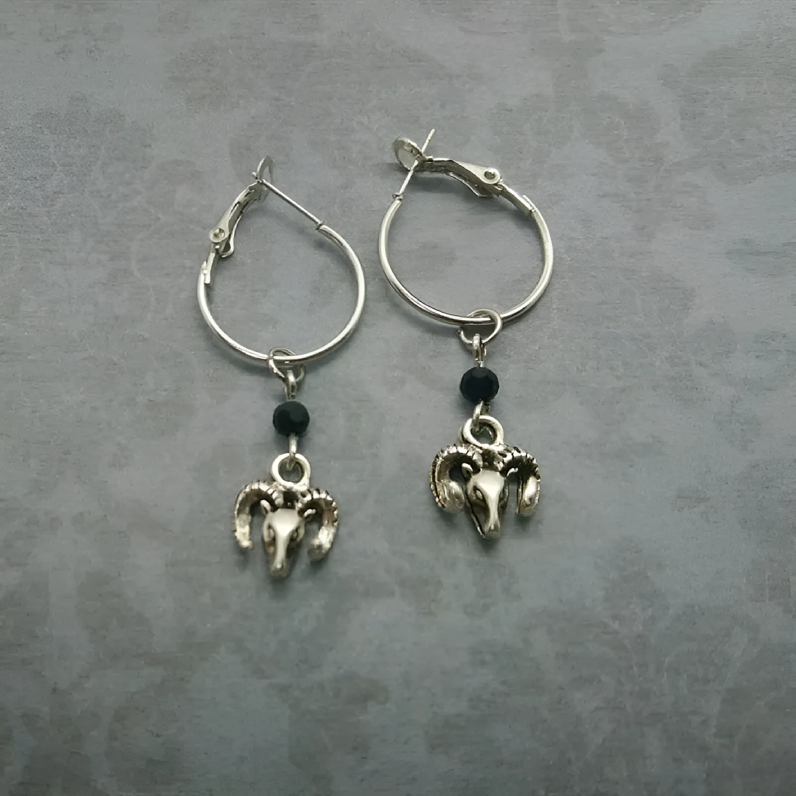 Silver round ring earrings for women with Tibetan antelope style design.
