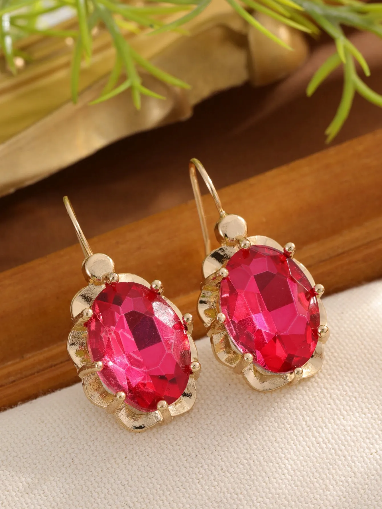 Pair of diamond studded earrings in polished zinc alloy, available in light blue, rose red, and royal blue colours