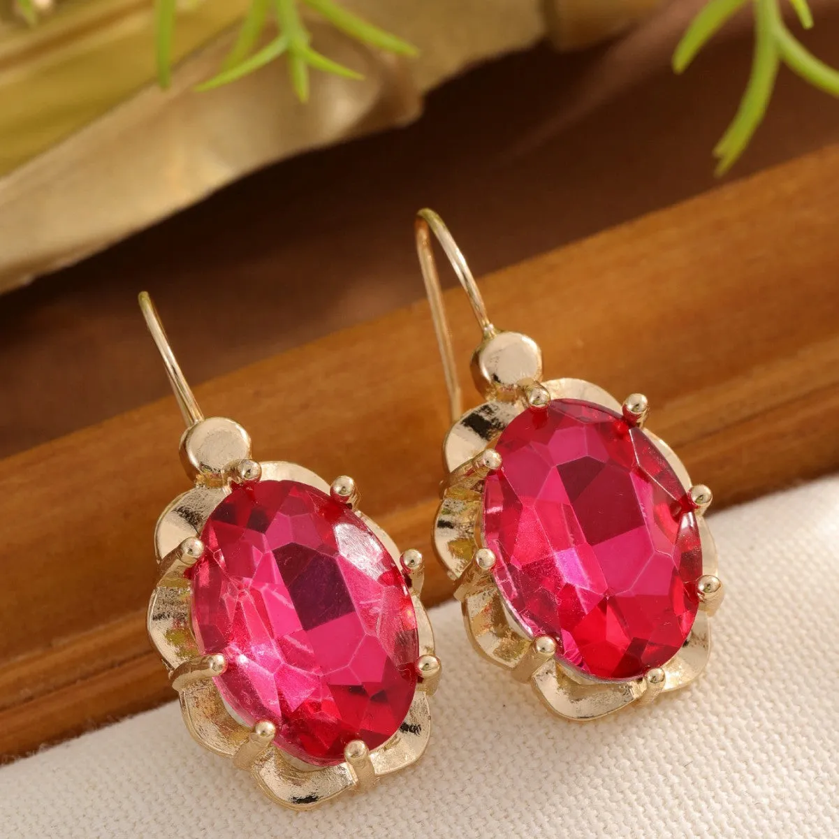 Pair of diamond studded earrings in polished zinc alloy, available in light blue, rose red, and royal blue colours