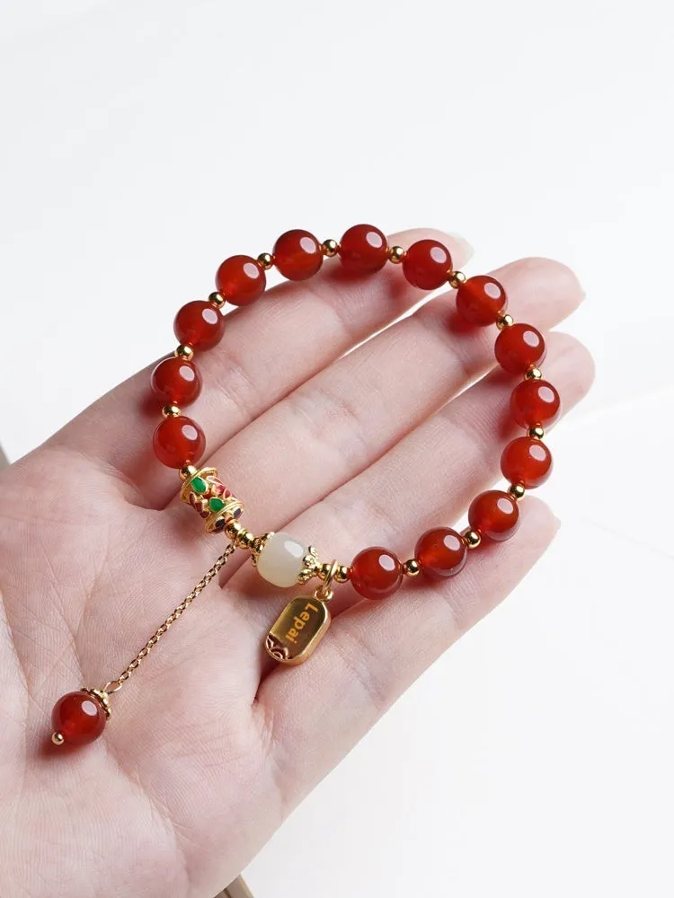 Women's bracelet with red agate and Hetian jade beads on gold-plated links in three design styles.