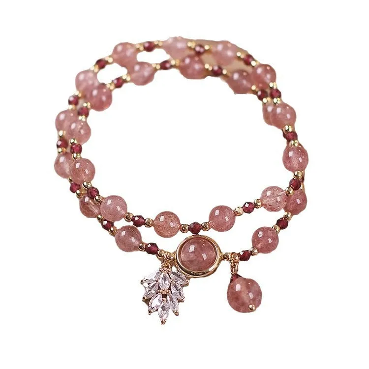Women's double circle crystal bracelet with flower-shaped crystal detail in Strawberry Quartz colour