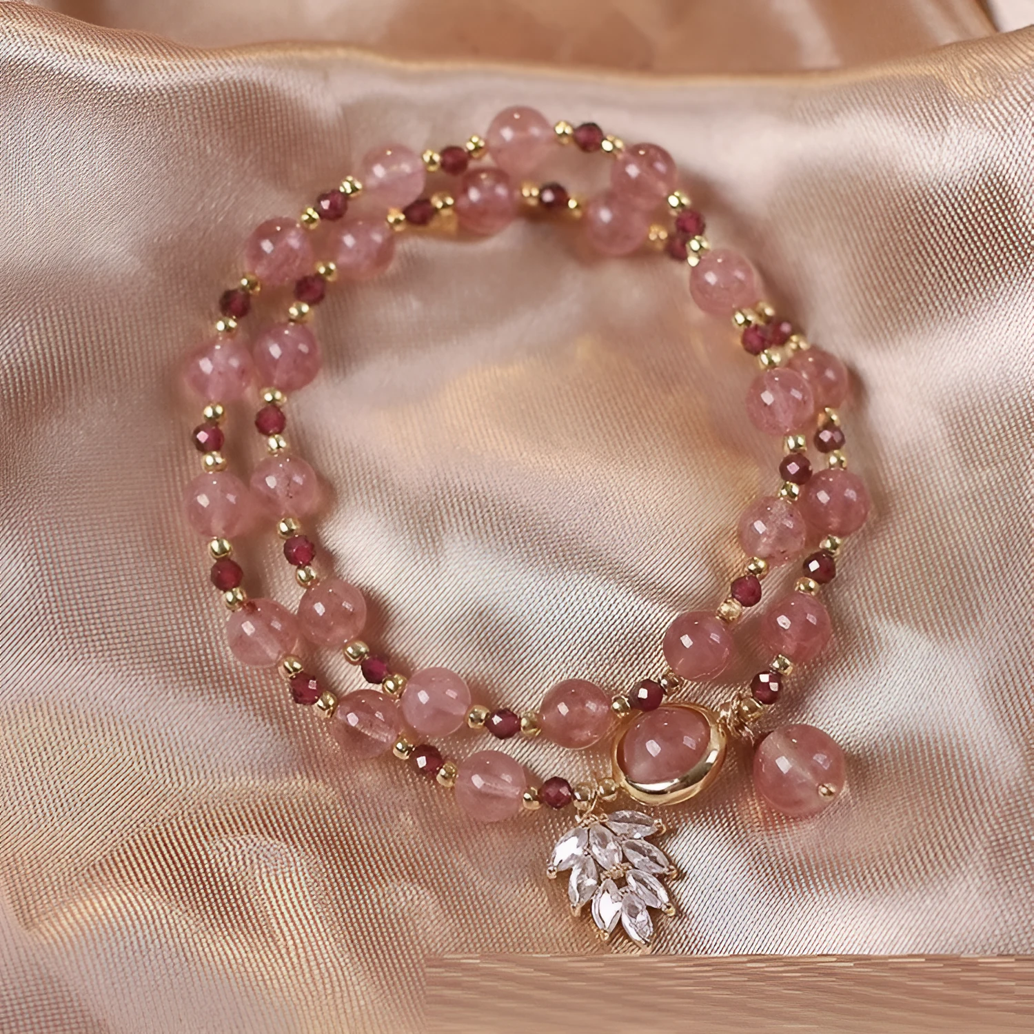 Women's double circle crystal bracelet with flower-shaped crystal detail in Strawberry Quartz colour
