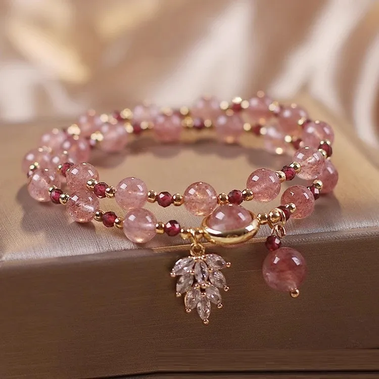 Women's double circle crystal bracelet with flower-shaped crystal detail in Strawberry Quartz colour