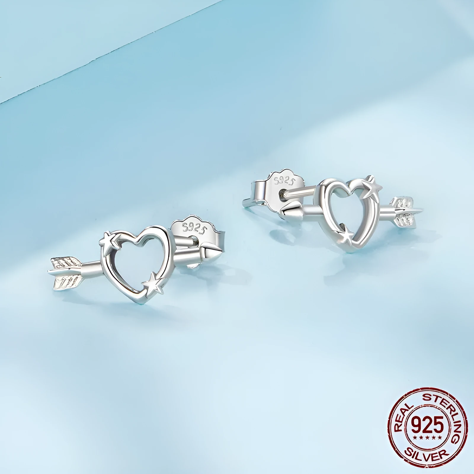 S925 sterling silver mini heart stud earrings with polished finish on white background