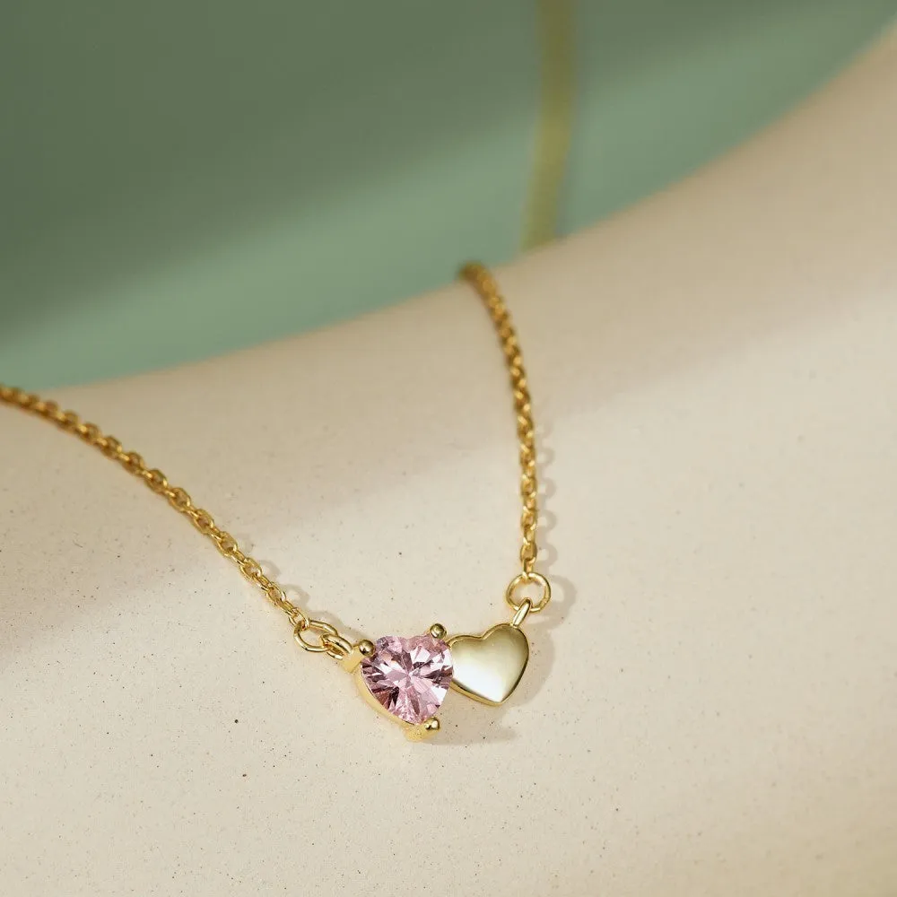 925 silver heart necklace with emerald zircon in gold finish on display