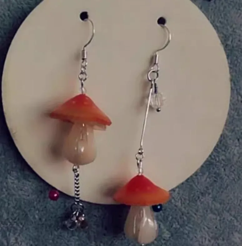 Resin heat shrinkable small mushroom earrings in yellow original style on plain background