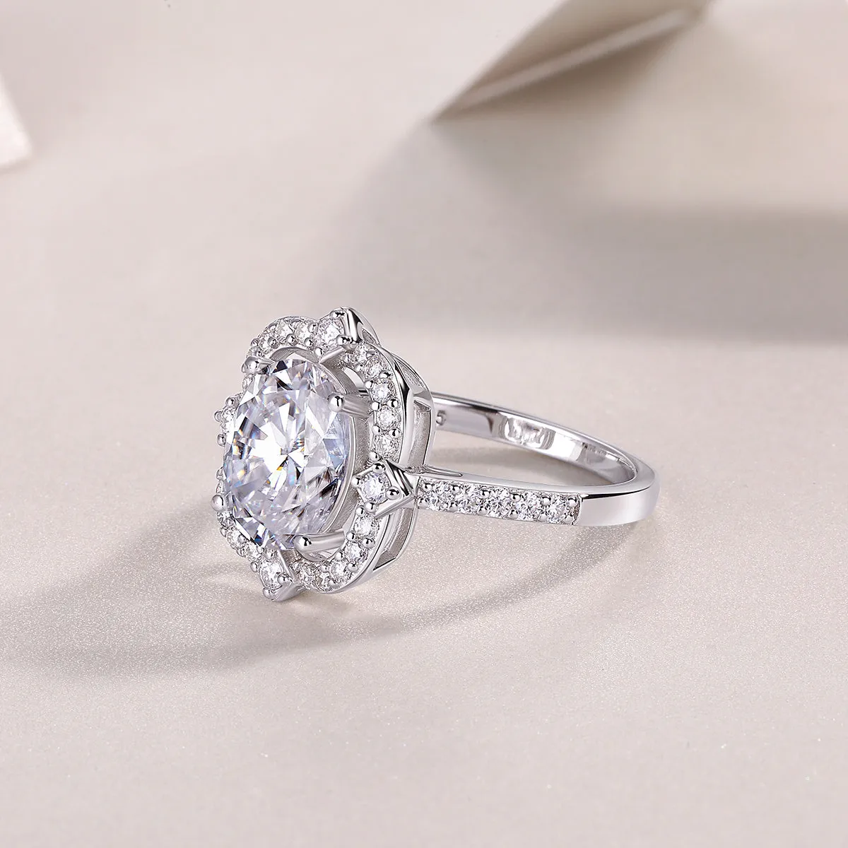 Camellia egg-shaped moissanite wedding ring set with S925 silver and platinum plating, showing centre stone and band