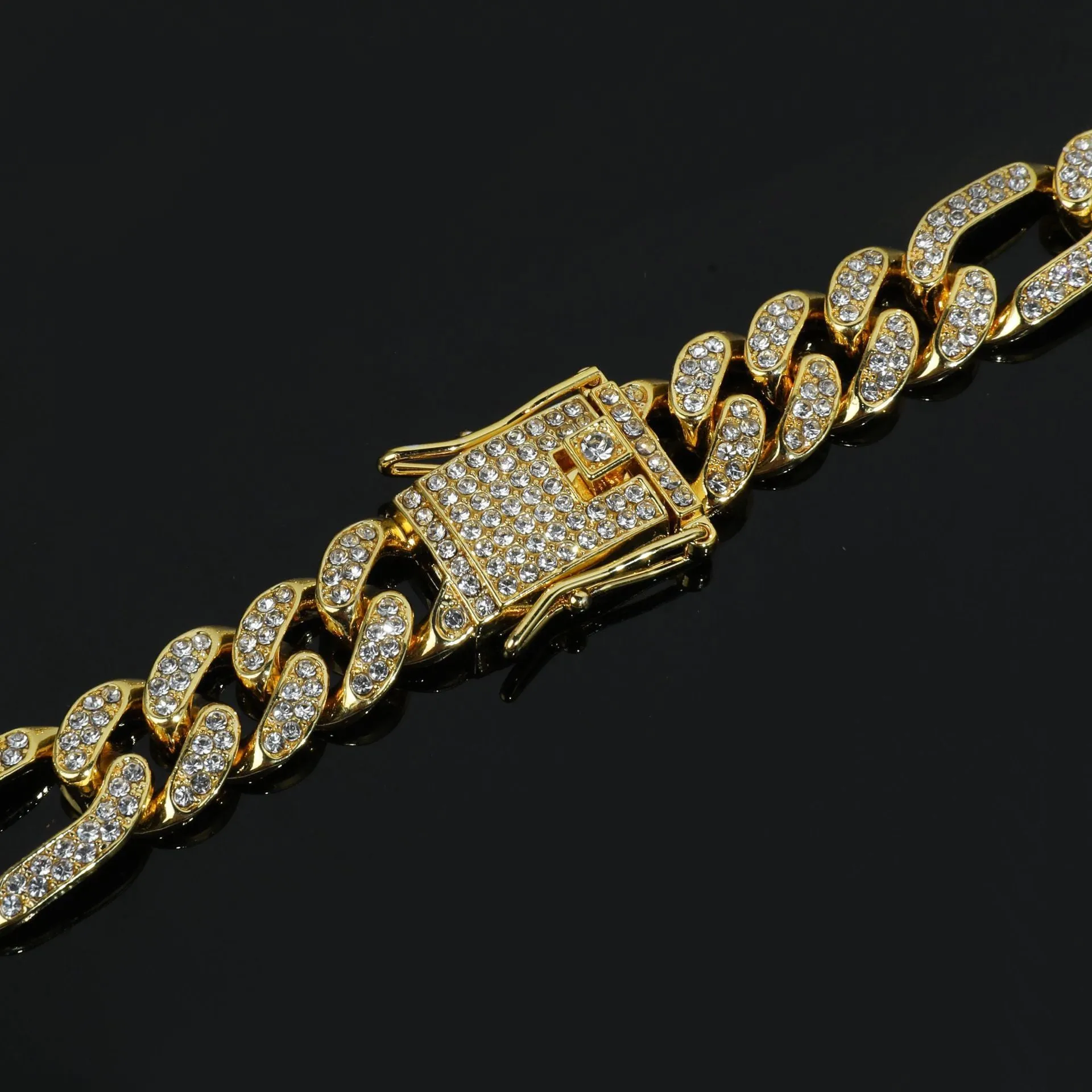 Rap style figaro chain necklace with geometric rhinestone pendant in silver colour on a plain background