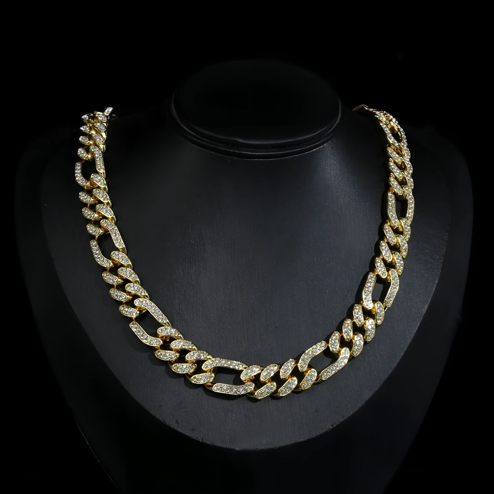 Rap style figaro chain necklace with geometric rhinestone pendant in silver colour on a plain background