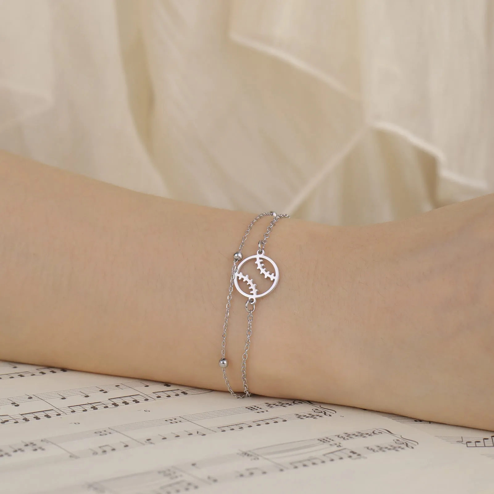 Stainless steel hollow baseball bracelet with double-layer chain in steel colour on wrist