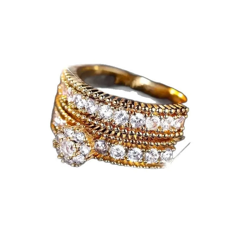 Two gold geometric zinc alloy rings with electroplated finish on white background