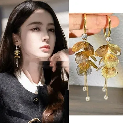 Gold floral petal pearl fringe drop earrings with electroplated alloy finish on neutral background