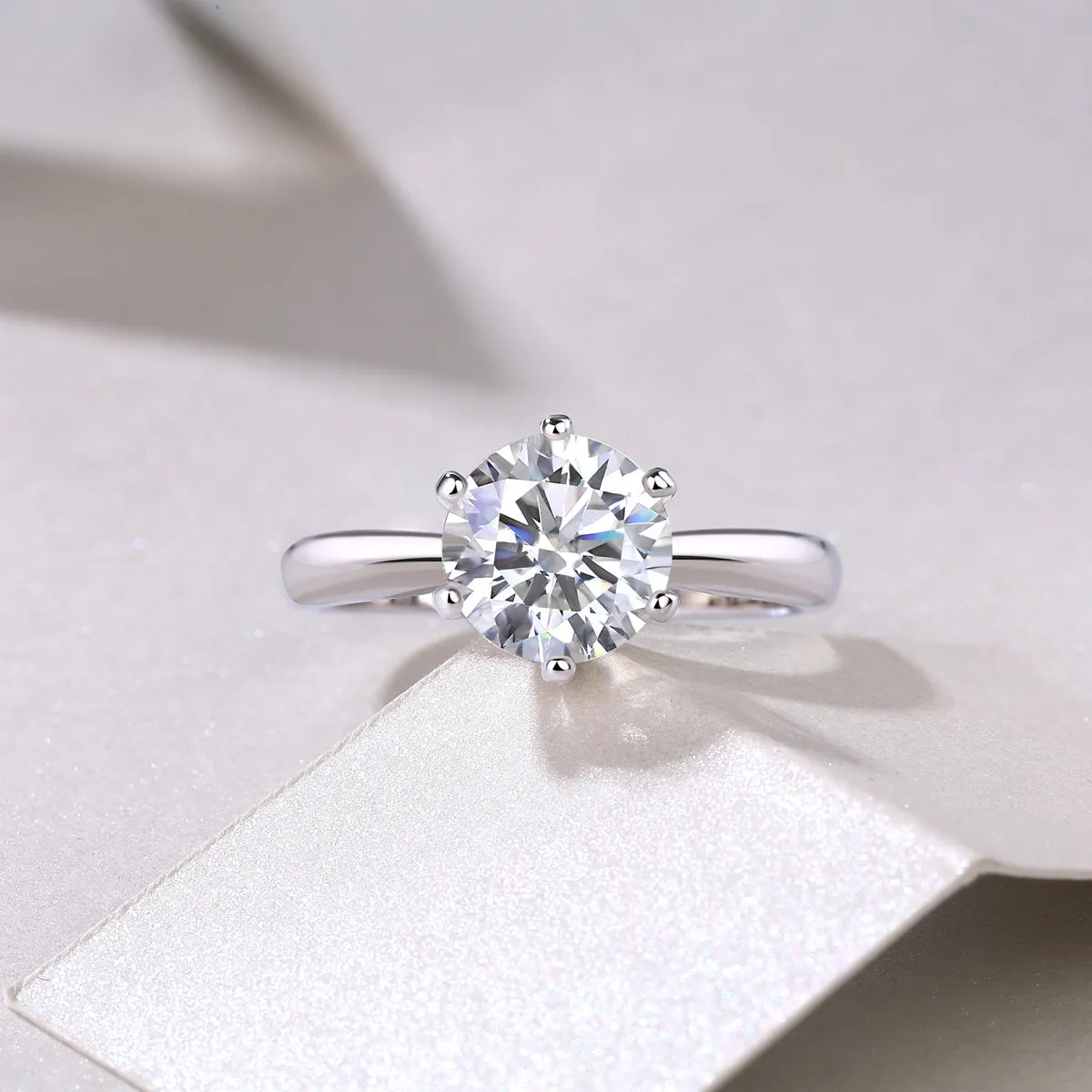 Classic six-prong moissanite wedding ring S925 silver platinum plated 1 carat stone on white background
