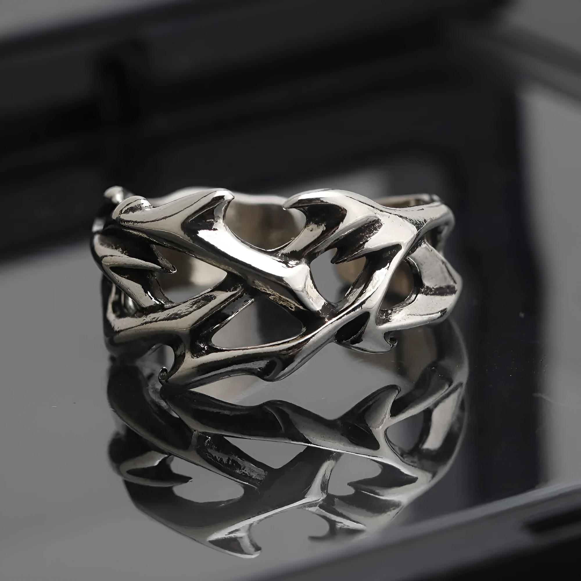 Copper men's ring with geometric thorn and flower design and adjustable band.