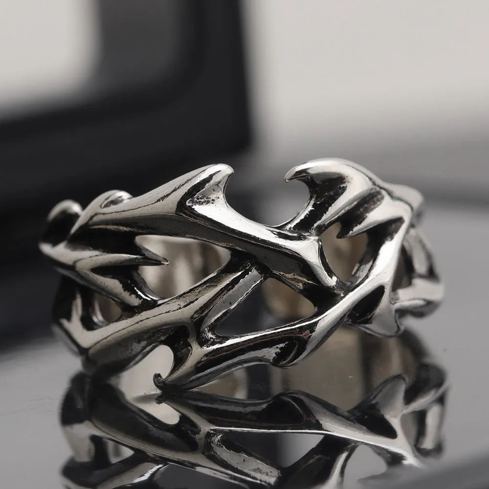 Copper men's ring with geometric thorn and flower design and adjustable band.