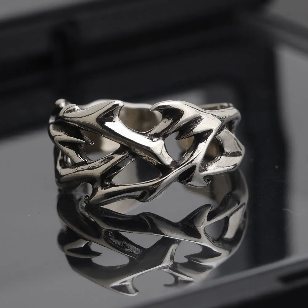 Copper men's ring with geometric thorn and flower design and adjustable band.