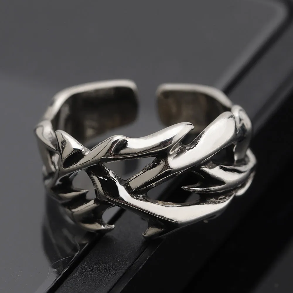 Copper men's ring with geometric thorn and flower design and adjustable band.